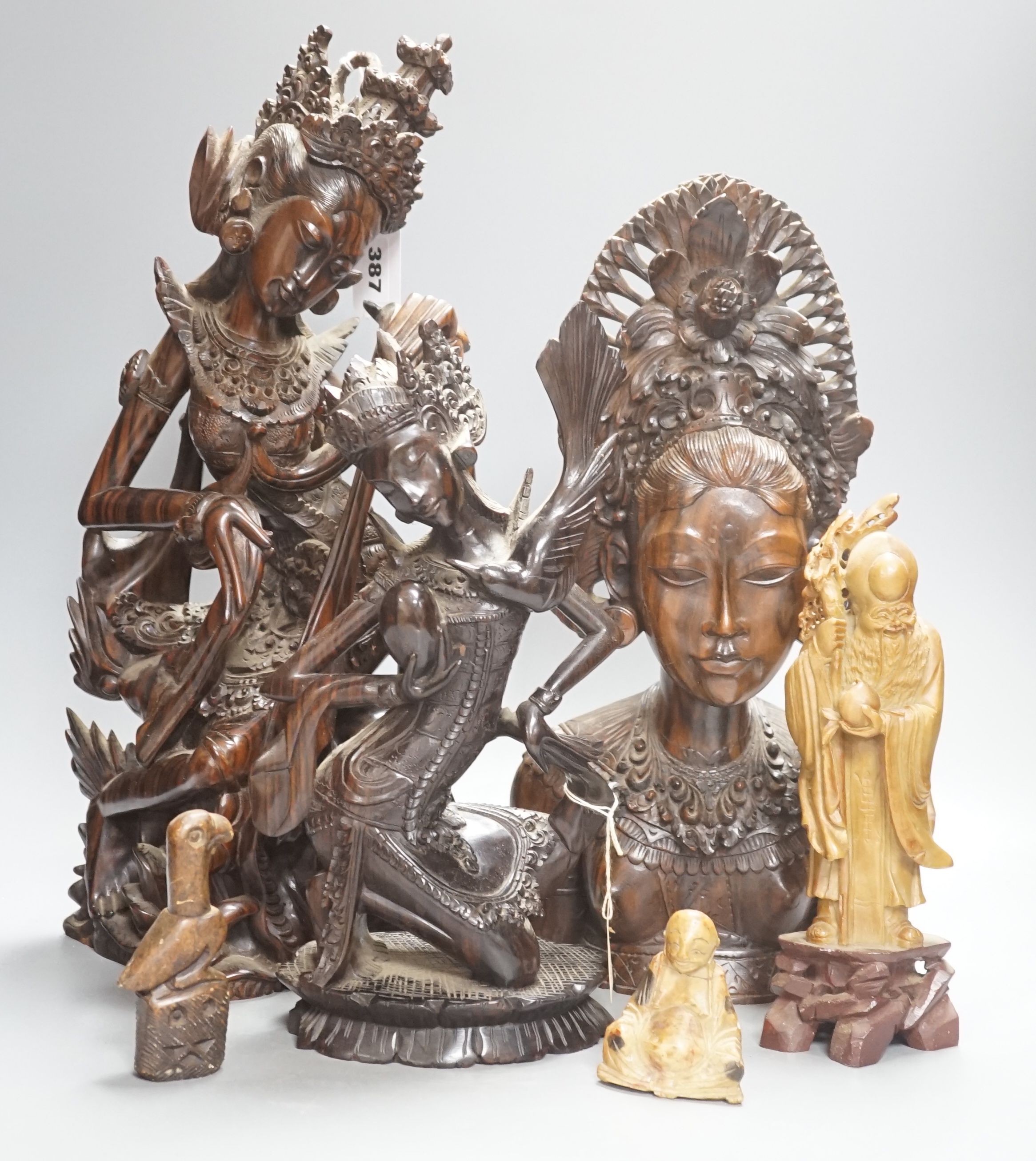 Three Balinese hardwood Macassar Ebony carvings, tallest 44.5 cm, two Chinese soapstone carvings and another